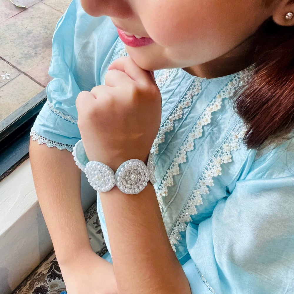 "Luxury ethnic hand bracelet in blue sequins and pearls, handcrafted with care for weddings, Diwali, and festive wear – highlighted in upscale posh venues of Hyderabad and Mumbai."