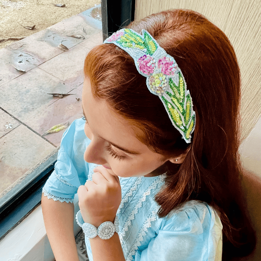 Colorful floral head accessory with pink, white, and yellow detailing, handmade for girls’ festive outfits.
