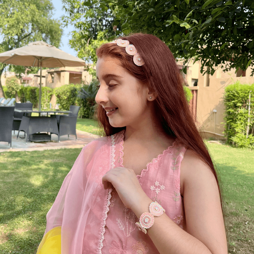 "Elegant pink-white sequin bracelet with pearls and stone centerpiece, artisan-crafted with easy wear and no-itch design, perfect accessory for ethnic wear like sharara or salwar – styled in Jaipur posh backdrop."