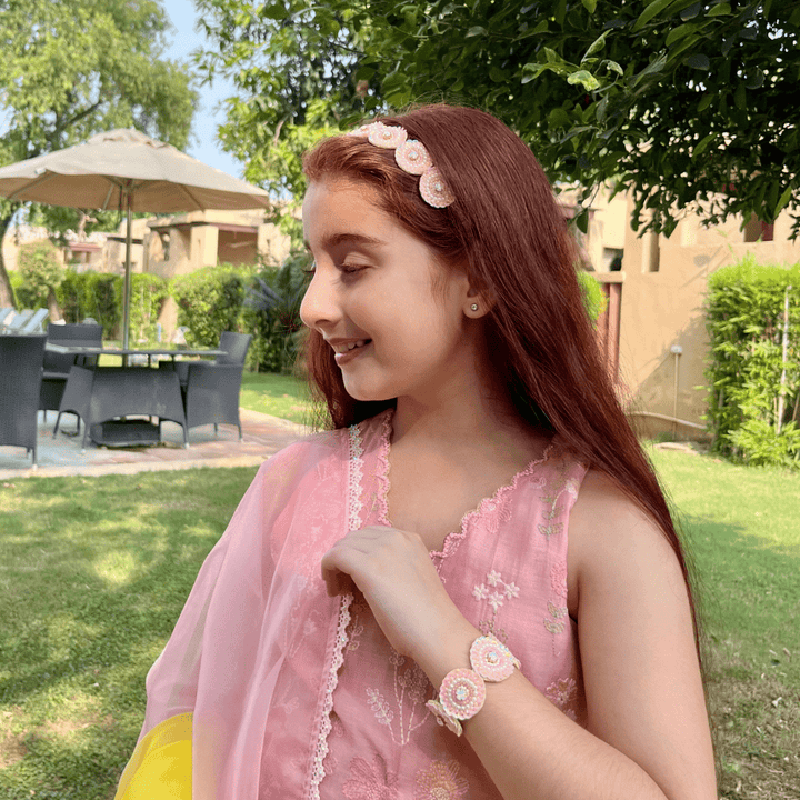 "Elegant pink-white sequin bracelet with pearls and stone centerpiece, artisan-crafted with easy wear and no-itch design, perfect accessory for ethnic wear like sharara or salwar – styled in Jaipur posh backdrop."