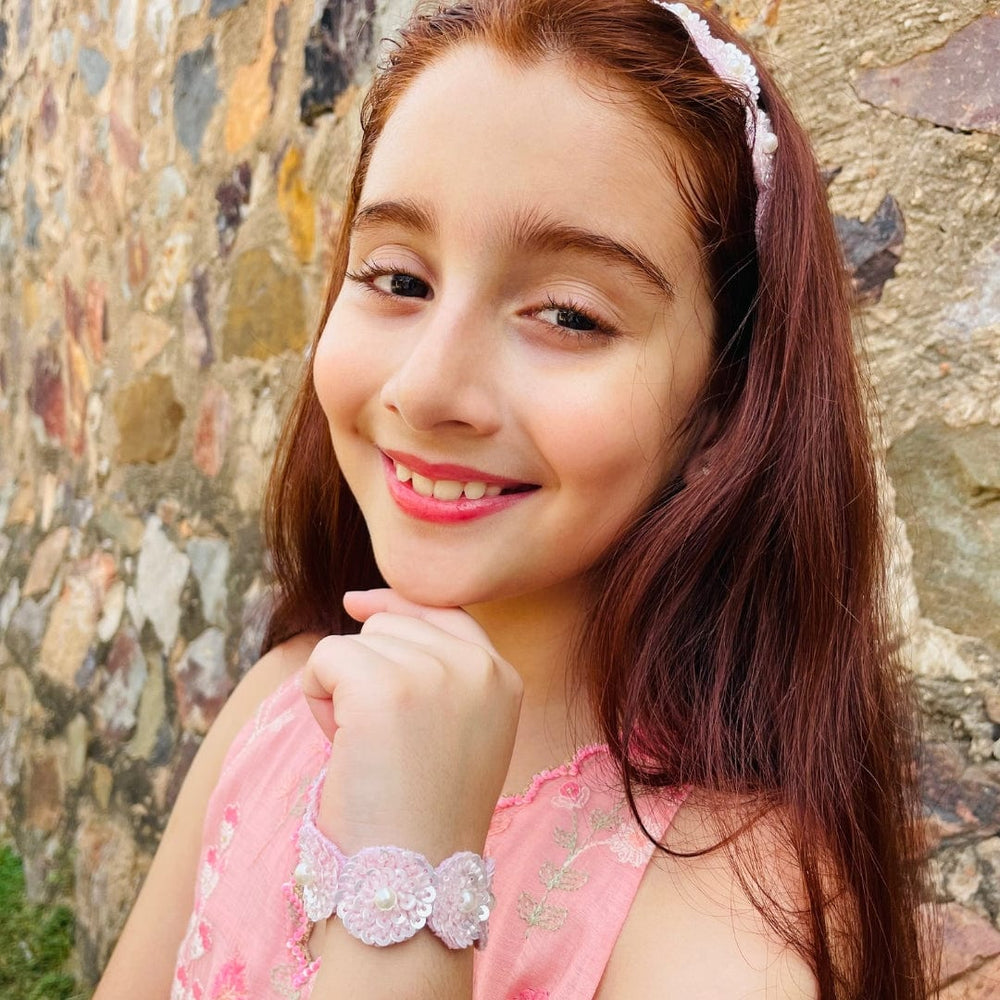 "Artisan-crafted pink sequin bracelet for girls, irritation-free with secure closure, versatile accessory for Diwali, weddings, and sangeet – highlighted in Jaipur luxury setting."