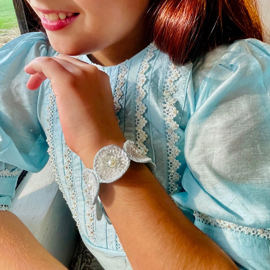 "Artisan-made blue sequin hand bracelet, soft and non-irritating for all-day wear, ideal ethnic jewelry for weddings, Diwali, haldi, and sangeet – showcased in an upscale posh telagna."