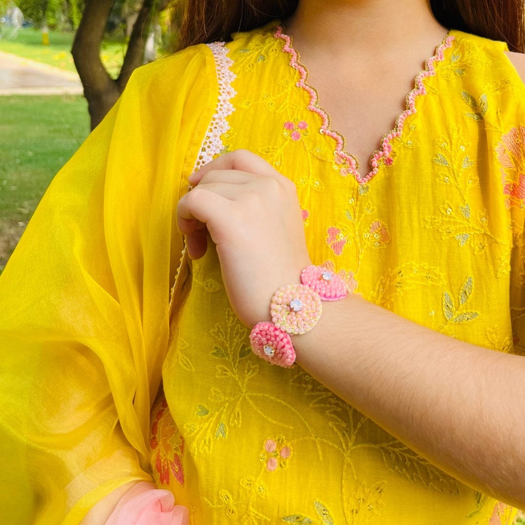 "Peach pink orange hand bracelet for girls with central stone, handcrafted by artisans, no-itch soft finish with fast closure, perfect for ages 0–14 with ethnic wear – styled in a luxury Hyderabad venue."
