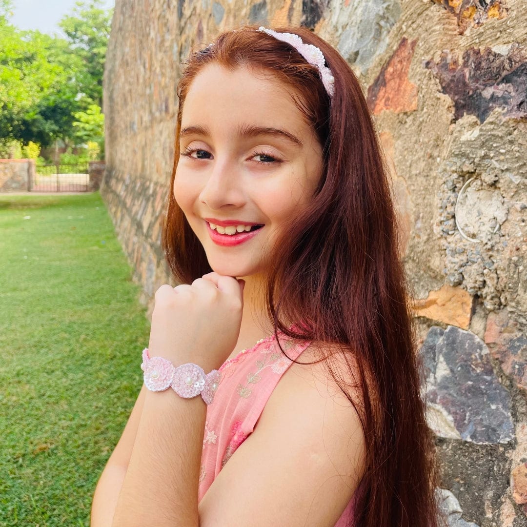 "Ethnic pink sequin hand bracelet for girls, artisan-made with soft, non-irritating finish and quick closure, ideal for Diwali, haldi, and weddings – showcased in Hyderabad luxury setting."