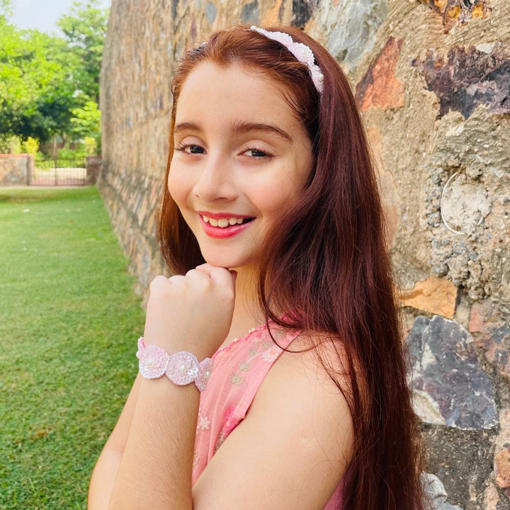 "Ethnic pink sequin hand bracelet for girls, artisan-made with soft, non-irritating finish and quick closure, ideal for Diwali, haldi, and weddings – showcased in Hyderabad luxury setting."