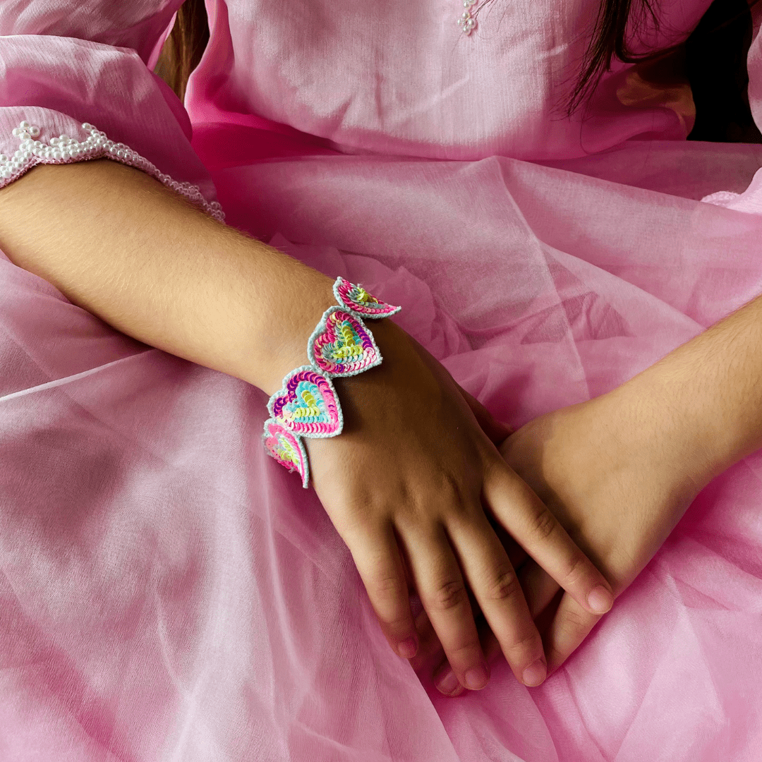 "Handmade Rainbow Heart Bracelet in bright colors, easy to wear, ideal for festive occasions, versatile for western and ethnic fashion – showcased in Hyderabad posh venue."