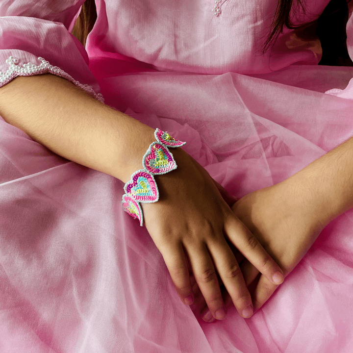 "Handmade Rainbow Heart Bracelet in bright colors, easy to wear, ideal for festive occasions, versatile for western and ethnic fashion – showcased in Hyderabad posh venue."