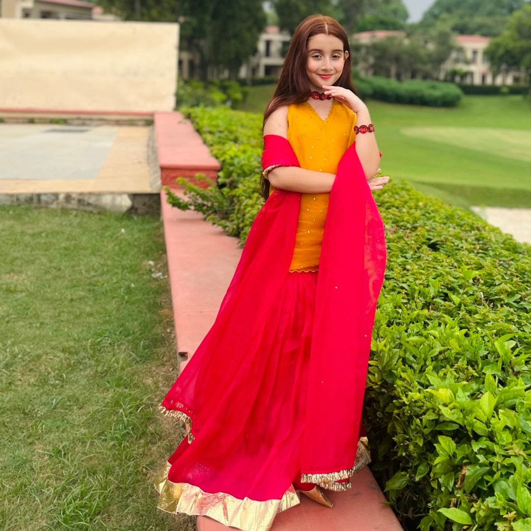Vibrant yellow and pink sharara set for girls, luxury kidswear for wedding occasions in Delhi and Hyderabad.